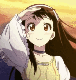 a girl with long black hair is wearing a headband and a yellow top .