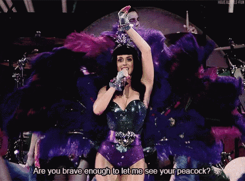 a woman singing into a microphone with the words are you brave enough to let me see your peacock behind her