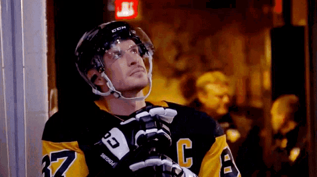 a hockey player wearing a jersey with the number 37 on it