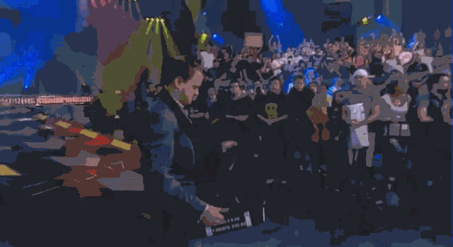a man in a suit stands in front of a crowd with a sign that says ' i love you '
