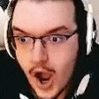 a close up of a man wearing headphones and glasses .