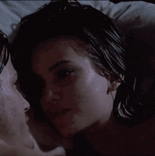 a close up of a woman 's face with a man 's head behind her