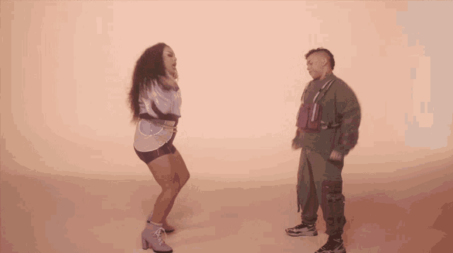 a man and a woman are dancing in a video