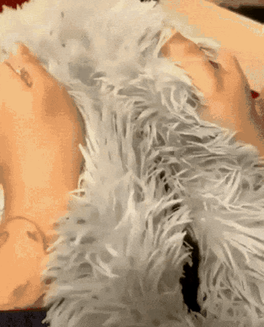 a person laying on a fluffy blanket with a tattoo on their foot
