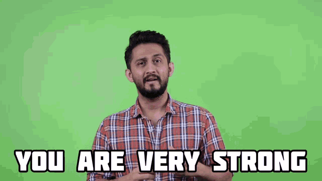a man in a plaid shirt says you are very strong on a green screen