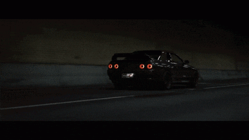 a car with a license plate that says nz on it is driving down the road