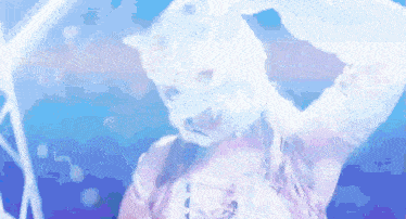 a woman wearing a white cat mask is standing in the water .