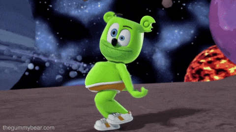 a green gummy bear is dancing with the website thegummybear.com visible in the background
