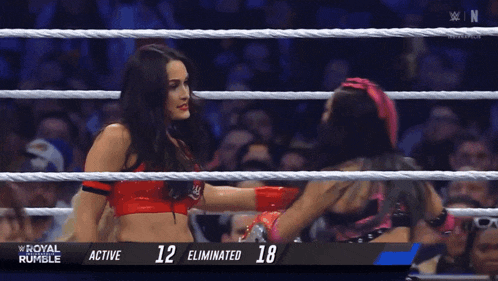 two women in a wrestling ring with the numbers 12 and 18 on the bottom