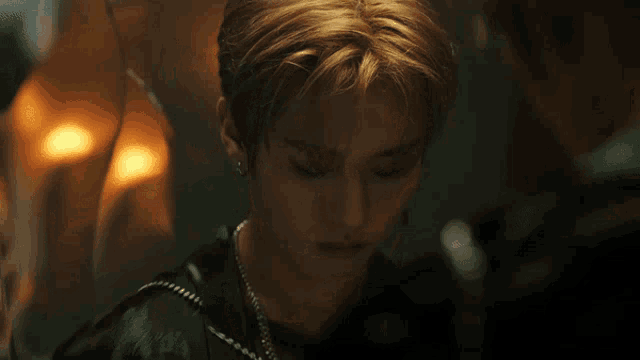 a close up of a young man looking at himself in the mirror
