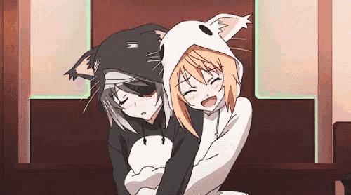 two anime girls are hugging each other and one has a cat hoodie on