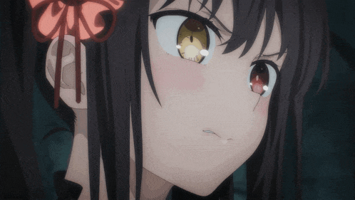 a close up of a girl 's face with a red bow on her hair