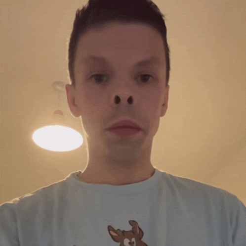 a man wearing a t-shirt with a cartoon deer on it