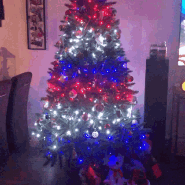 a christmas tree with red white and blue lights and decorations