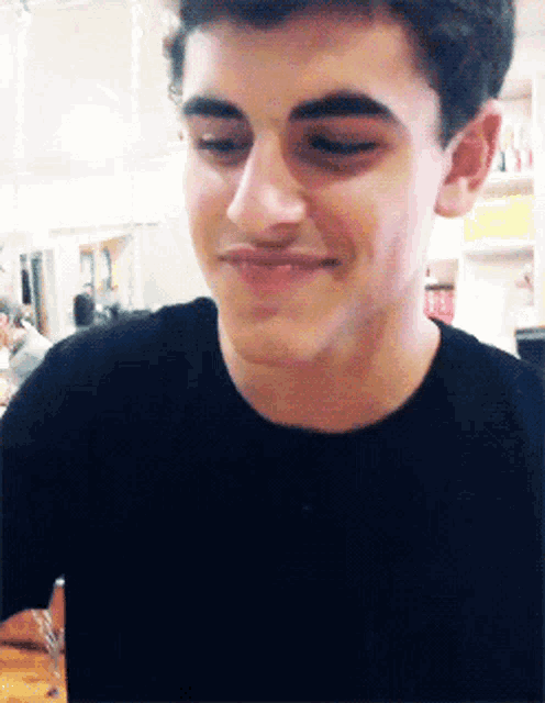 a close up of a young man 's face with a smile on his face