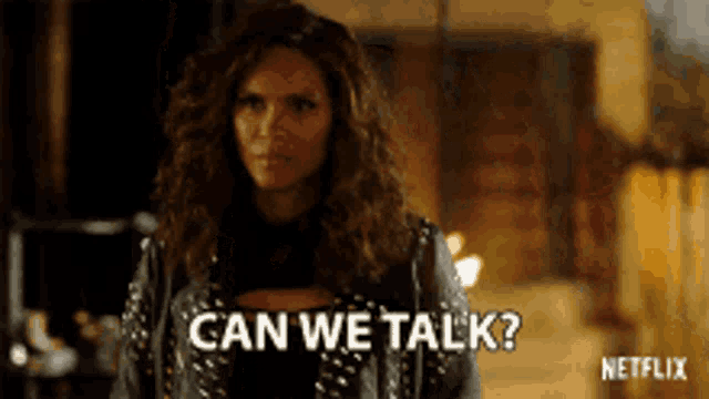 a woman in a leather jacket says can we talk .