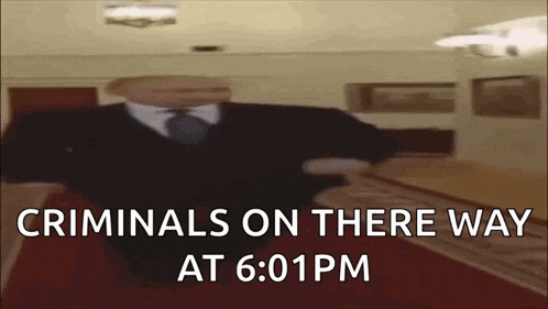 a man in a suit and tie is standing in a room with the words criminals on there way at 6:01 pm