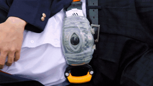 a man in a suit has a clear container on his belt