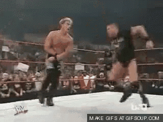 two men are wrestling in a ring with the words make gifs at gifsoup.com on the bottom right