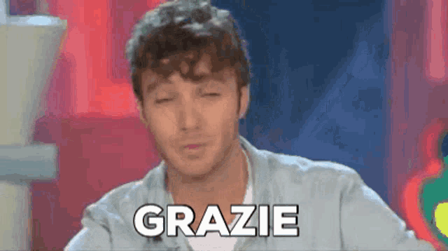 a man with his eyes closed says grazie