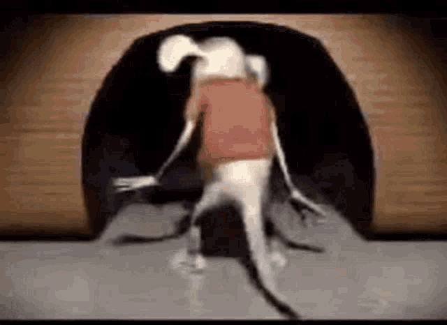 a cartoon dog is coming out of a hole in a wall .