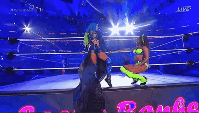 two women are wrestling in a ring with the words live on the screen