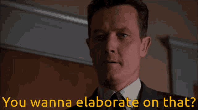 a man in a suit and tie is asking if he wanna elaborate on that