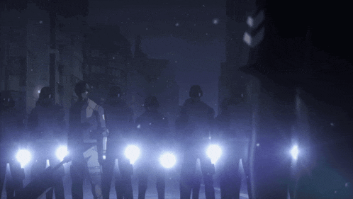 a group of police officers are standing in the dark