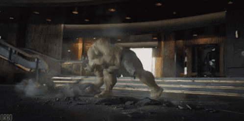 the hulk is jumping out of a hole in the ground in a room .