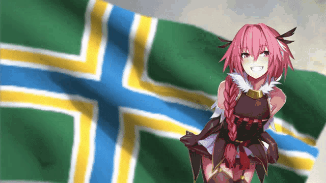 a girl with pink hair is smiling in front of a green yellow and blue flag