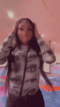 a woman wearing a jacket that says ' ed ' on it