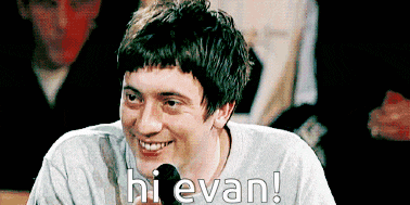 a man is smiling and says hi evan in front of a crowd