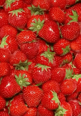 a heart shaped strawberry is surrounded by strawberries