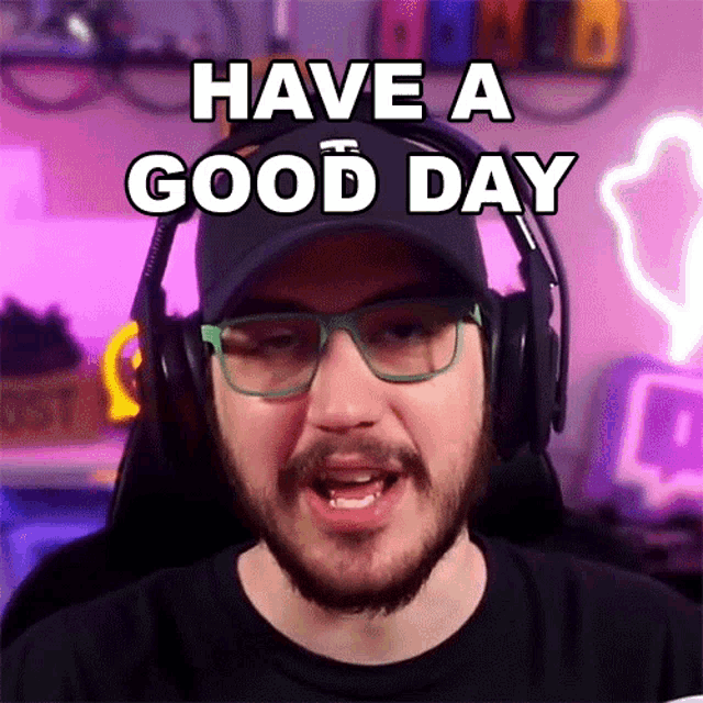 a man with a beard wearing headphones and glasses says have a good day