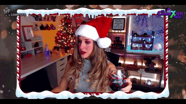 a woman wearing a santa hat and holding a glass of wine
