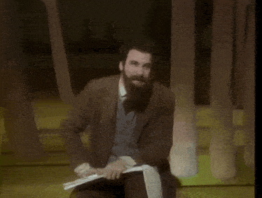 a man with a beard is holding a piece of paper and says " you can say to yourself "
