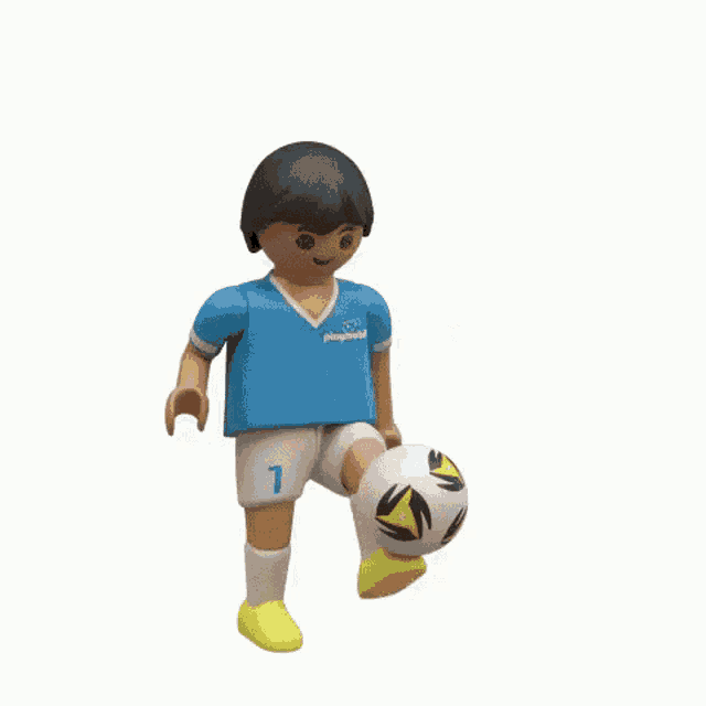 a playmobil figure is holding a soccer ball in his hand .
