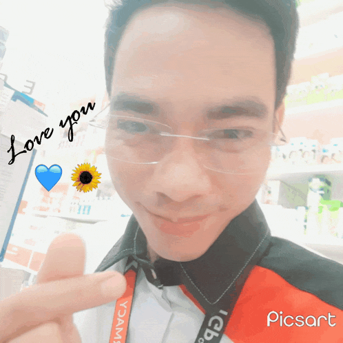 a young man wearing glasses and a lanyard that says icb on it