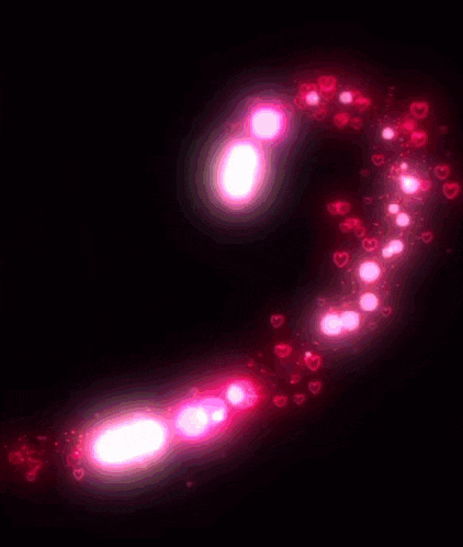 a heart made of pink hearts on a dark background