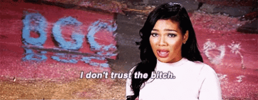 a woman is standing in front of a wall with the word bgc painted on it .