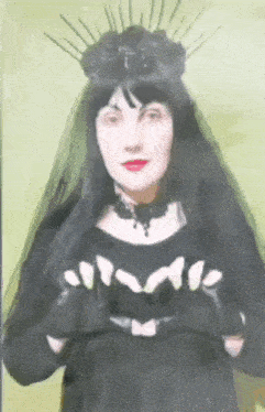 a woman in a black dress with a veil and a crown