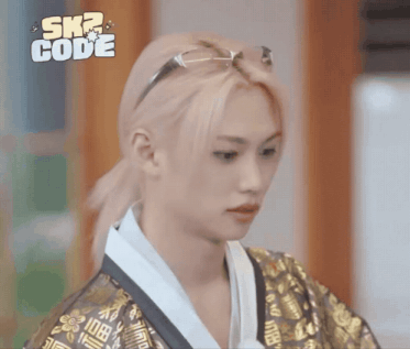 a person wearing a kimono and sunglasses with the words sk2 code on the bottom right