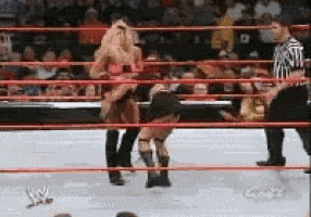 a woman is wrestling another woman in a wrestling ring