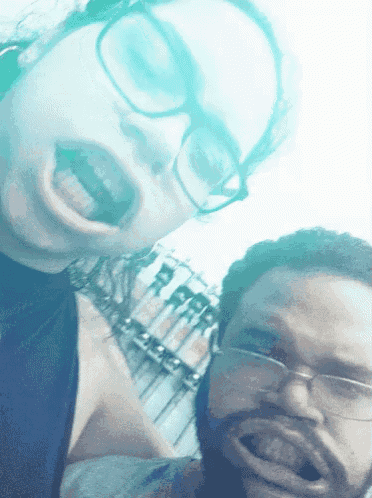a man and a woman are posing for a picture and the woman is making a funny face