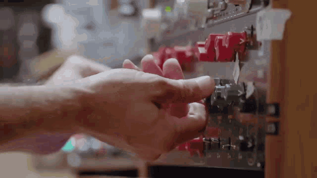 a close up of a person 's hand pressing a button on a device .