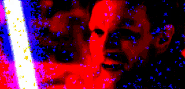a blurry picture of a man 's face with a red and blue background