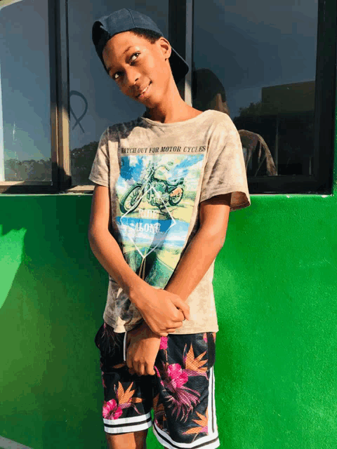 a young boy wearing a t-shirt that says without for motor cyclists