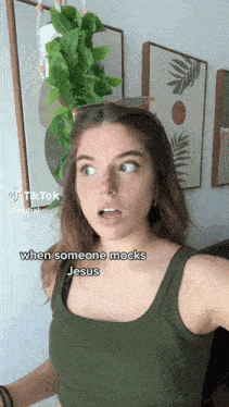 a woman in a green tank top is making a funny face while wearing sunglasses ..