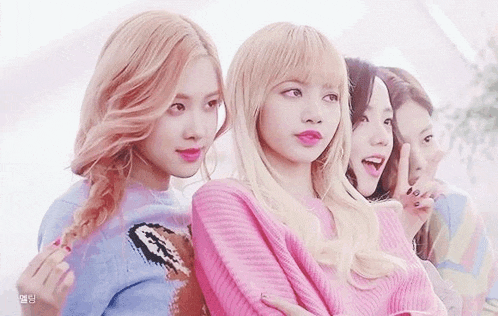 a group of girls are standing next to each other in a line .