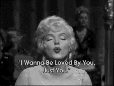 a black and white photo of a woman with the words " i wanna be loved by you just you "